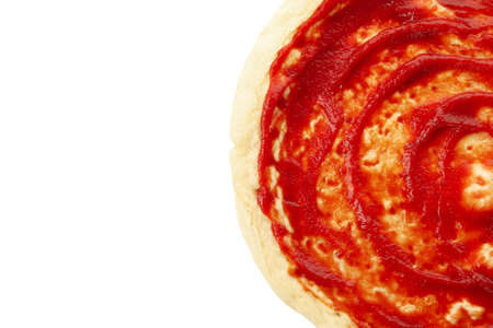 Rolled out pizza dough with sauce isolated on white backgroundの写真素材