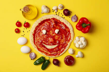 Ingredients for cooking pizza on yellow background, top viewの写真素材