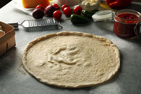 Concept for cooking pizza with ingredients on gray table