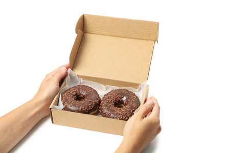 Female hands hold carton box with donuts, isolated on white background