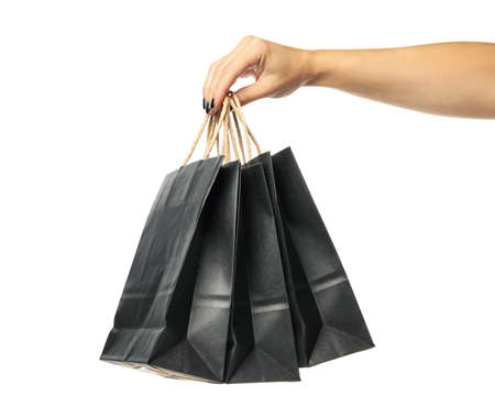 Female hand hold paper bags, isolated on white backgroundの写真素材
