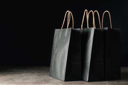 Paper bags against black background, space for textの写真素材