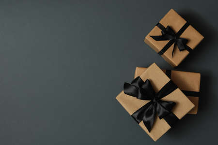Craft gift boxes with bow on gray background