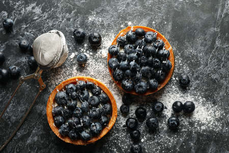 Concept of tasty lunch with blueberry pies on dark backgroundの写真素材