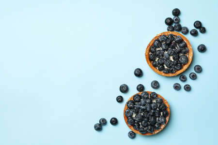Blueberry pies on blue background, top viewの写真素材