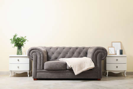 Cozy interior with sofa against light beige wallの写真素材