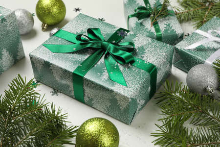 Gift boxes, pine tree branches and baubles on white backgroundの写真素材