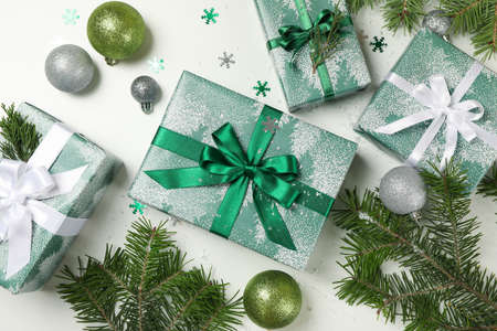 Gift boxes, pine tree branches and baubles on white backgroundの写真素材