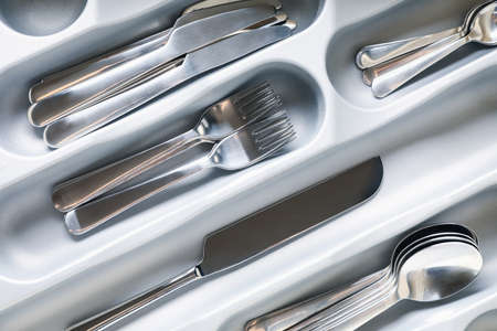 Set of different cutlery on whole background, close up