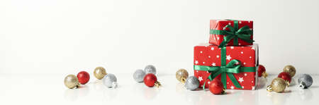 Christmas boxes and baubles on white background
