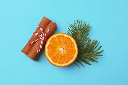 Mandarin, cinnamon and pine branch on blue backgroundの写真素材