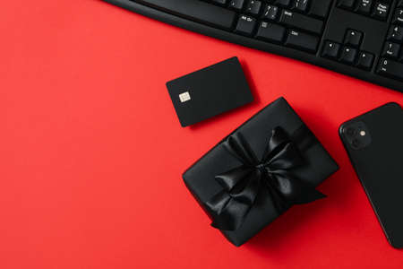 Sale concept with gift box on red backgroundの写真素材