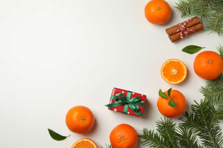 Mandarins, pine branches, cinnamon and gift box on white backgroundの写真素材