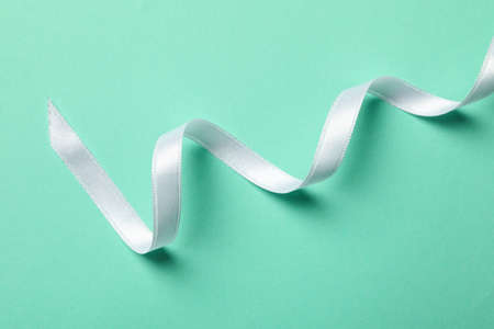 White curly ribbon on mint background, close upの写真素材