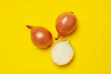Fresh raw onion on yellow background, top viewの写真素材