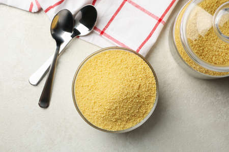 Concept of breakfast with couscous on gray table