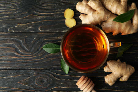 Fresh ginger and cup of tea on wooden backgroundの写真素材
