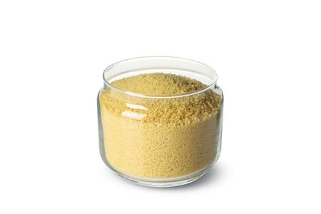 Glass jar with couscous isolated on white backgroundの写真素材