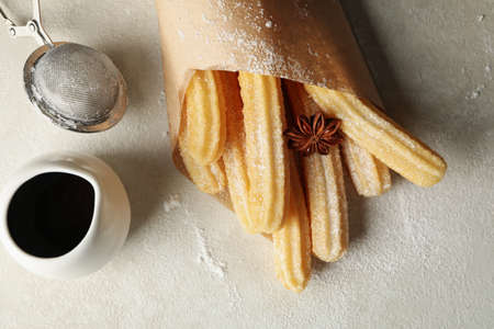 Concept of sweet lunch with churros on gray table