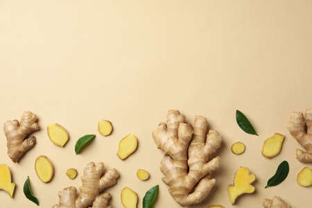 Fresh ginger and leaves on beige background, top viewの写真素材