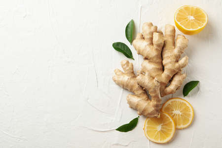 Fresh raw ginger and lemon on white background