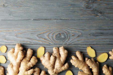 Fresh ginger on wooden background, top viewの写真素材