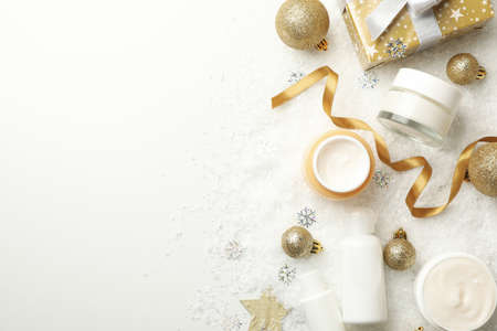 Concept of face care with cosmetics on background with decorative snowの写真素材
