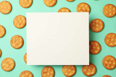 Space for text on mint background with cracker biscuits