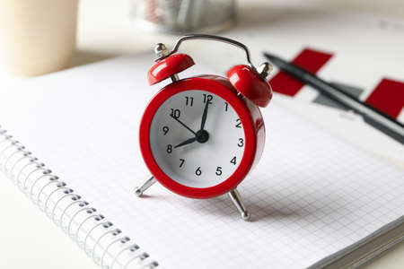 Concept of finance planning with alarm clock on white table