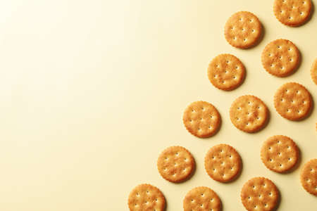 Tasty cracker biscuits on beige background, space for textの写真素材