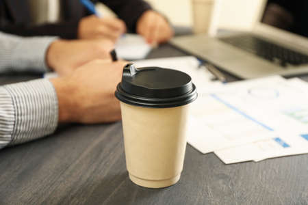Business partners doing a financial planning on black wooden tableの写真素材