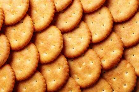 Tasty cracker biscuits on whole background, close upの写真素材