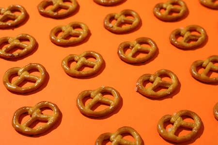 Flat lay with cracker pretzels on orange background