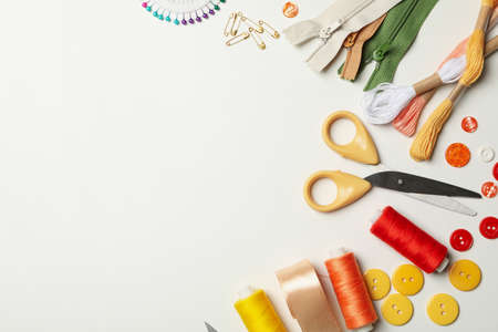 Sewing supplies on white background, space for text