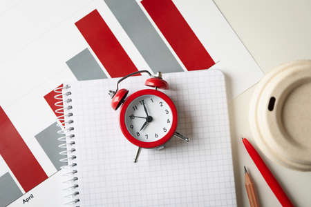 Concept of finance planning with alarm clock on white tableの写真素材