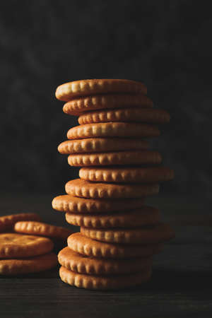 Pile of cracker biscuits on wooden table, close upの写真素材