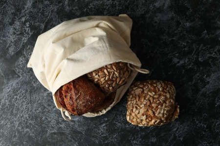 Cotton bag with rye buns on black smokey table