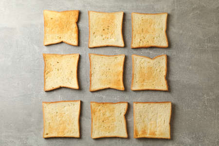 Flat lay with toast breads on gray background
