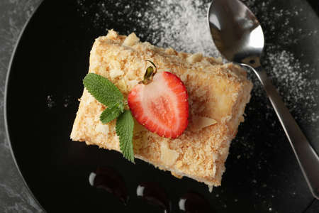 Plate with piece of tasty Napoleon cake, close up