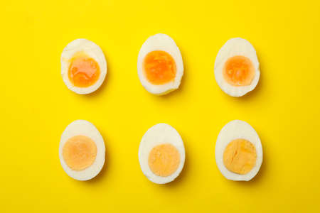 Hard boiled eggs on yellow background, top viewの写真素材