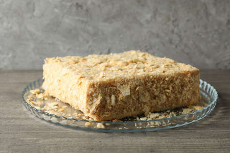 Tray with delicious Napoleon cake on gray table