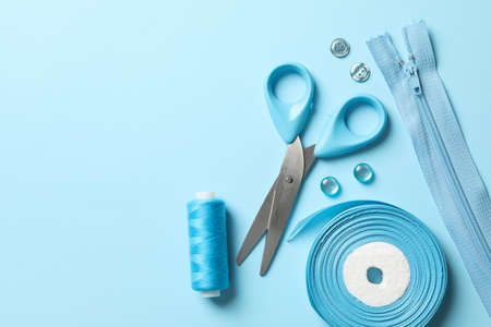 Blue sewing supplies on blue background, top viewの写真素材