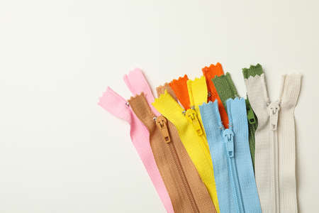 Color zippers on white background, space for textの写真素材
