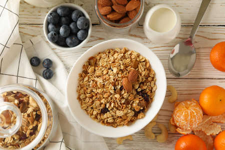 Concept of tasty breakfast with granola on wooden background