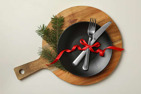 Wooden board with New year table setting on white background