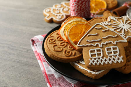 Concept of holiday food with Christmas cookie on gray table