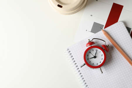 Concept of finance planning with alarm clock on white table