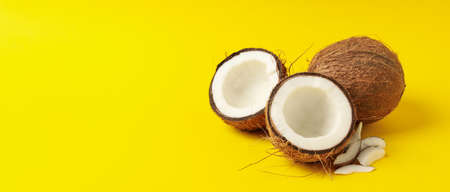Group of tasty fresh coconut on yellow background