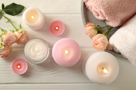 Body care concept with scented candles on white wooden backgroundの写真素材