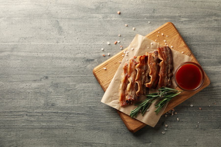 Concept of tasty snack with board of fried baconの写真素材
